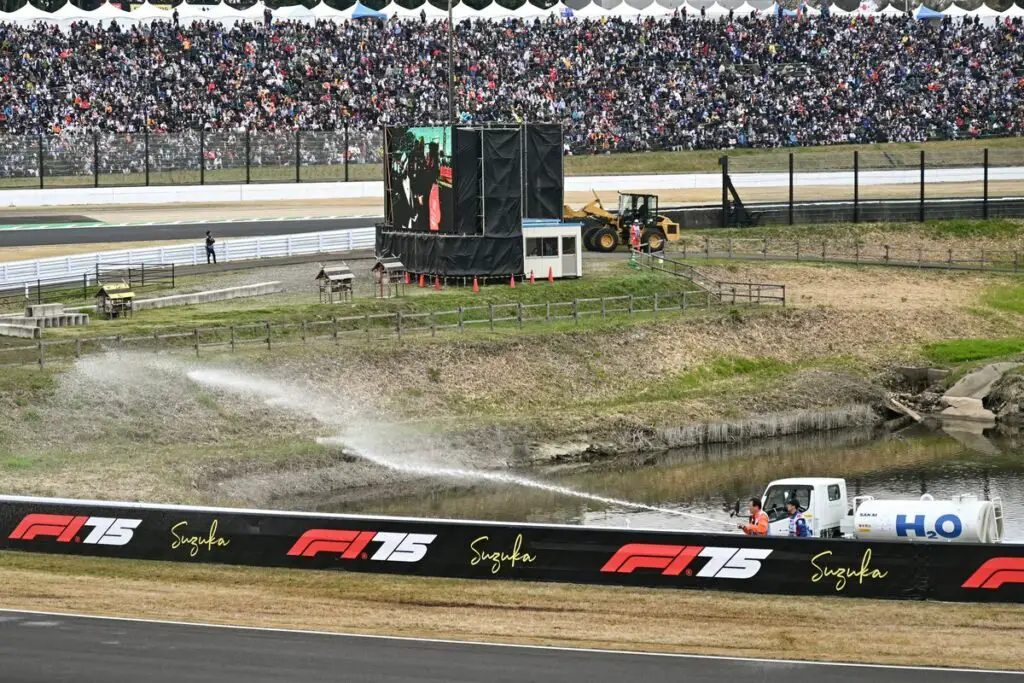 Firefighters Spray Water to Douse Grass