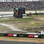 Firefighters Spray Water to Douse Grass