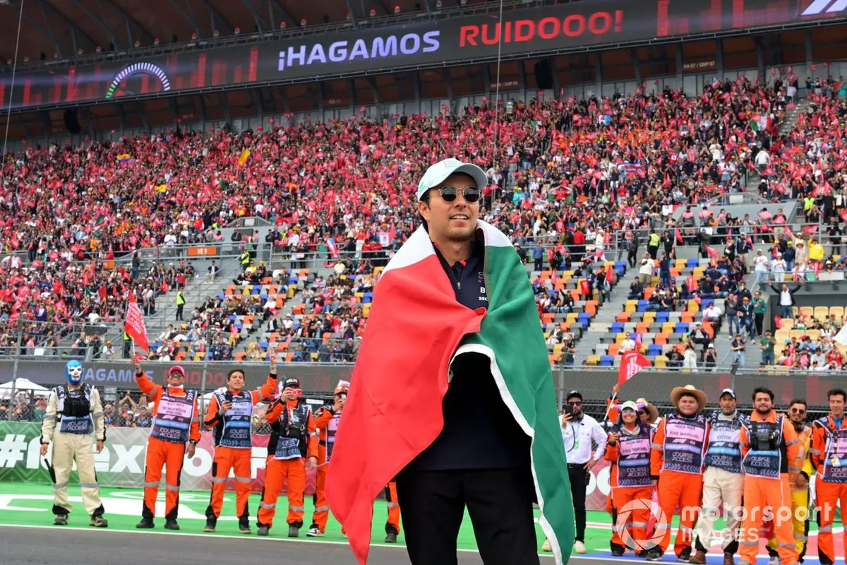 Sergio Perez Celebrates with Mexican Flag at Red Bull Racing