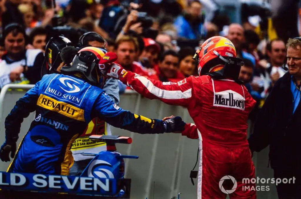 Fernando Alonso, Renault, and Michael Schumacher, Ferrari exchange congratulations in Parc Ferme.